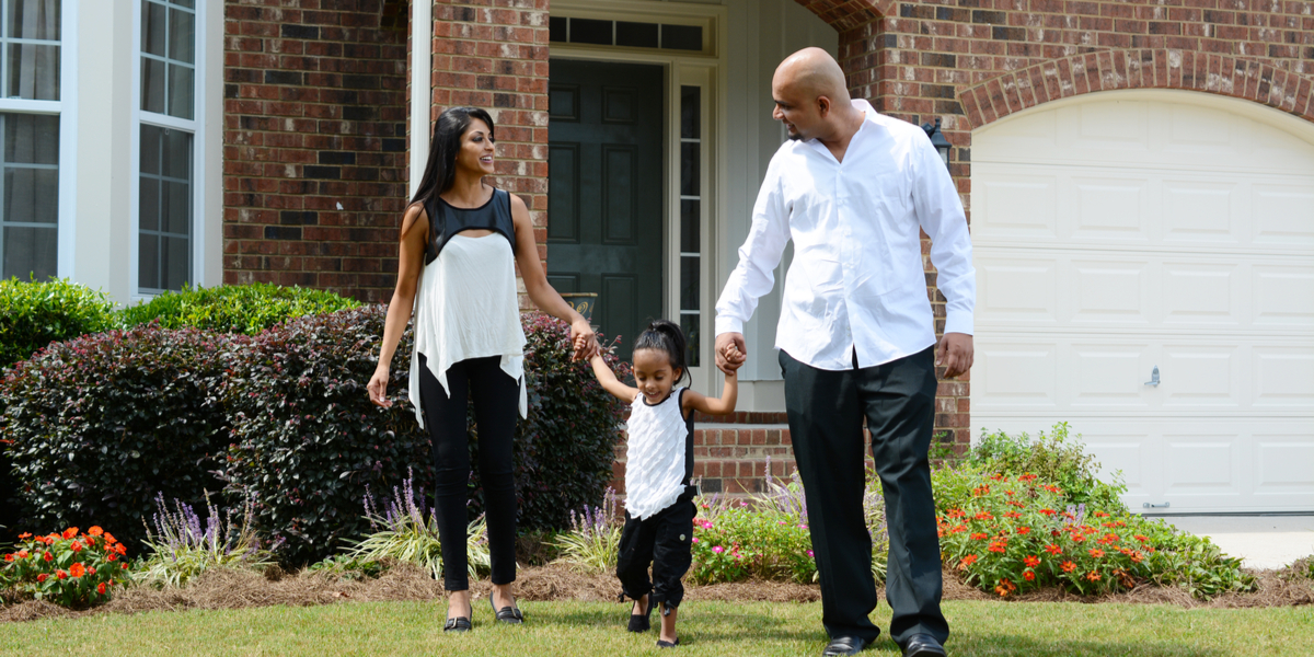 Family outside house. Energy efficiency and environmental justice.